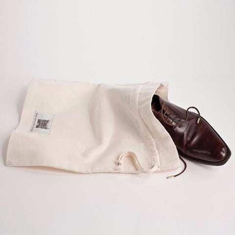 A Luxury Flannel Shoe Travel Bag With A Men's Shoe Sticking Out Of It