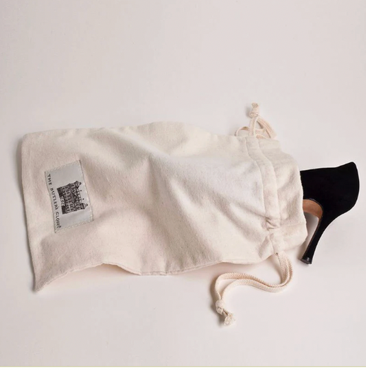 Black High-Heel Shoe Partially Inside Cream Cotton Shoe Bag