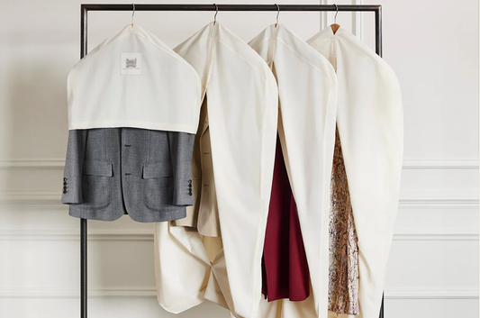 Clothes Hanging on Rack Covered With White Dust Covers for Closet Storage