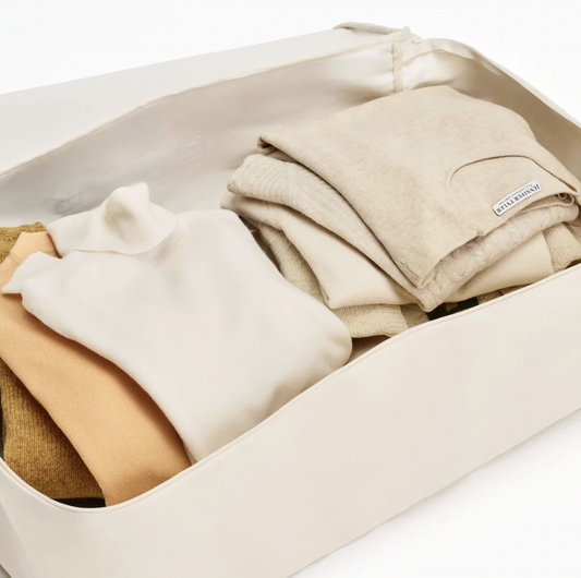 Folded Sweaters Stored In Flat Cotton Storage Bag