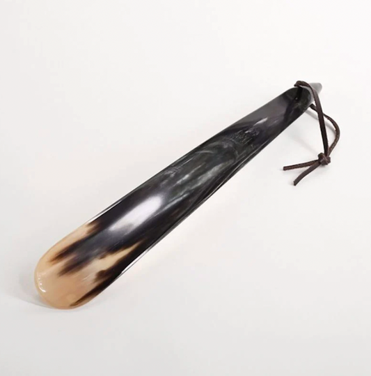 Handcrafted Horn Shoehorn With Leather Hanging Loop on White Background