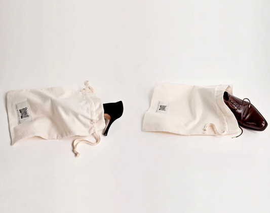 Leather Dress Shoes Partially Placed Inside Cream Cotton Shoe Dust Bags