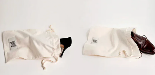 Two White Drawstring Shoe Bags Holding Black Heel and Brown Dress Shoe