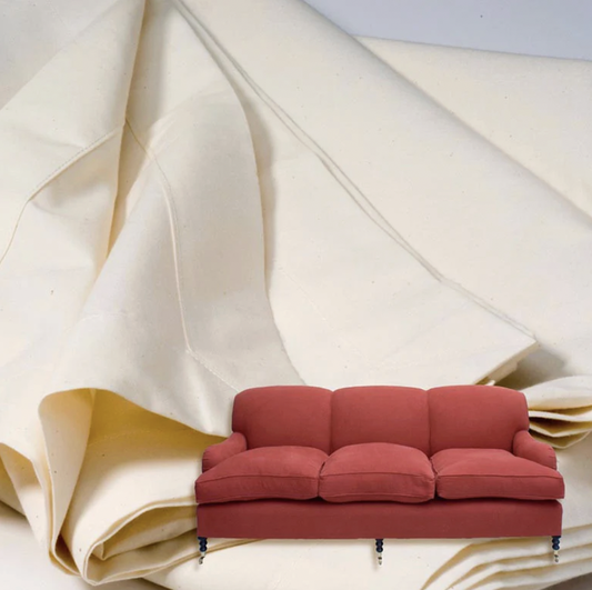 Red leather sofa with protective fabric covering backdrop