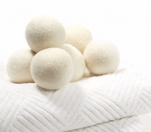 Wool dryer balls displayed on folded white textured towels