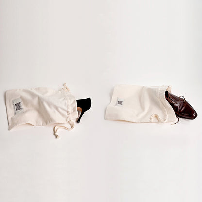 Two Luxury Travel Shoe Bags. One With A Woman's Shoe And One With A Man's Shoe Sticking Out.