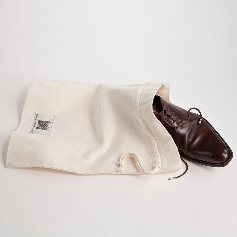 A Cotton Travel Shoe Bag With A Men's Brown Shoe Sticking Out