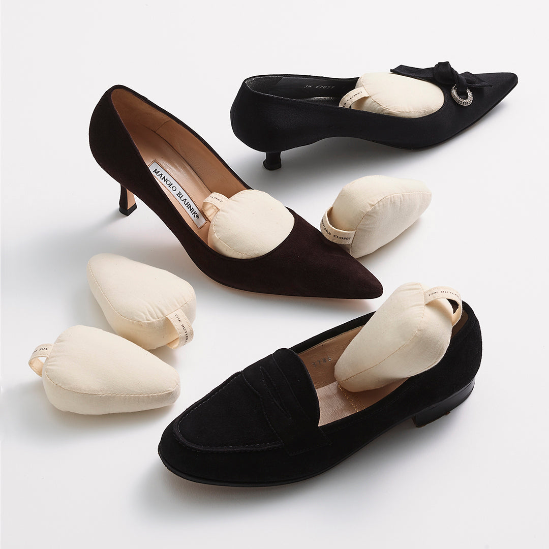Cotton Shoe Shapers In And Around Three Black Shoes